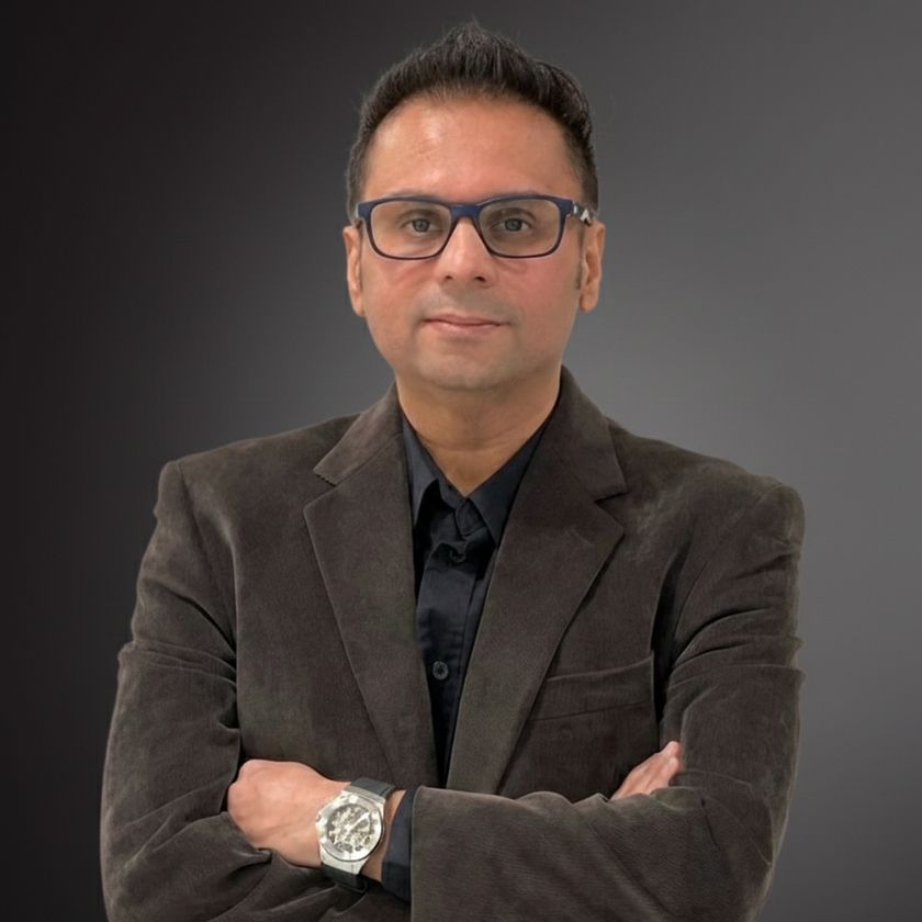 Sheharyar Gulraiz, arms crossed, wearing glasses and a dark corduroy blazer.